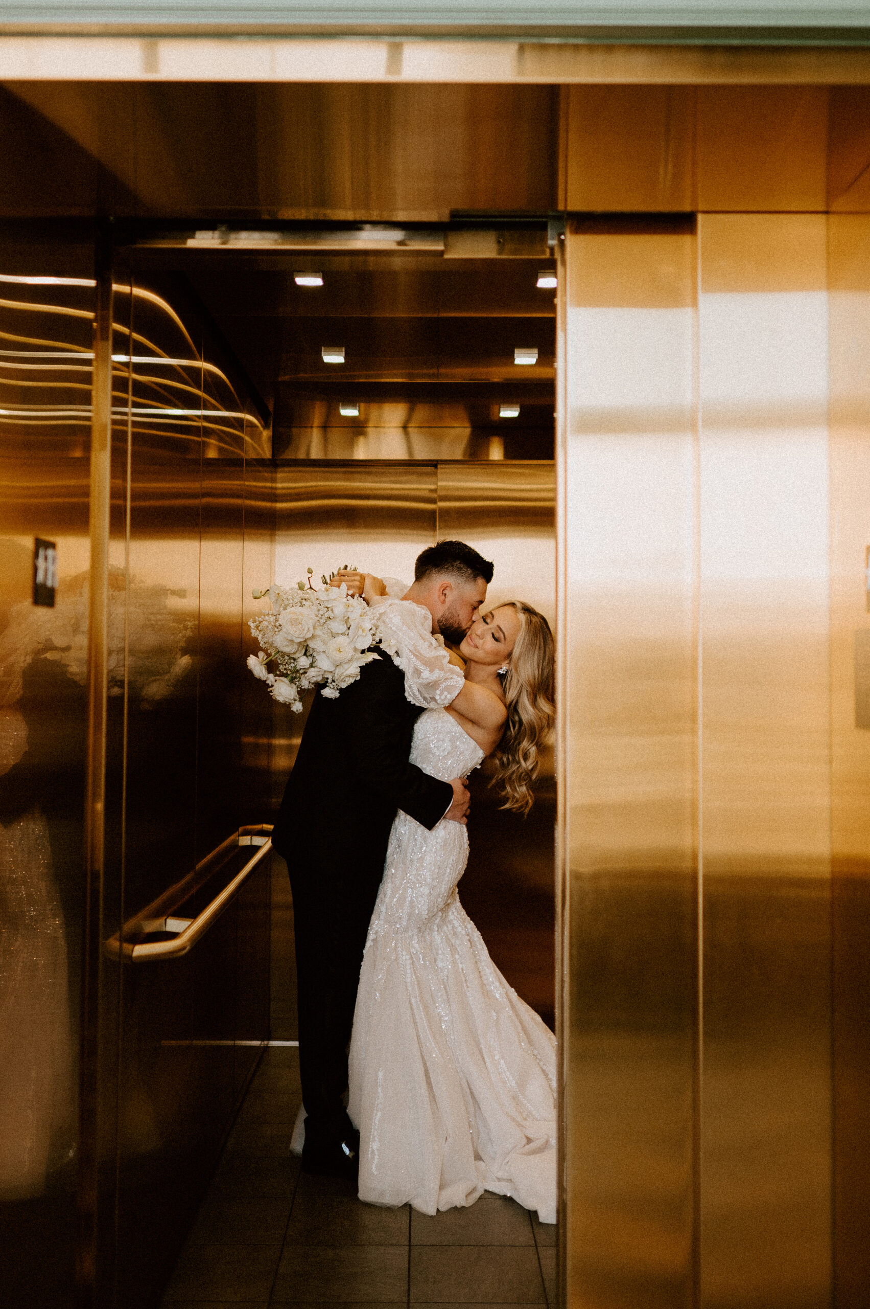 bride and groom elevator wedding photography