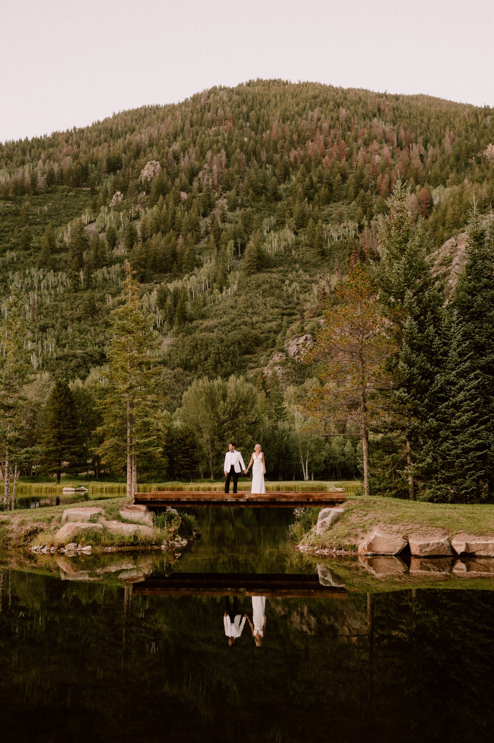 bride and groom on bridge at The Dunbar in Aspen Colorado
